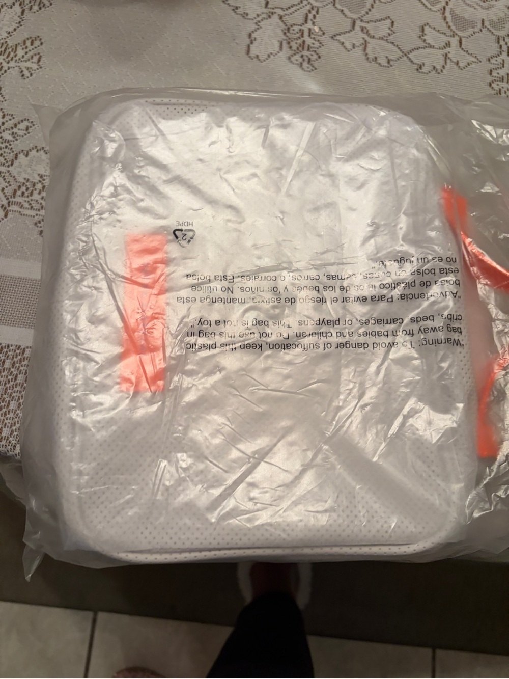 Drunk Elephant white and neon orange bag.